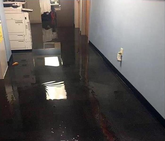 Flooded office, copier, standing water in a building concept of water damage