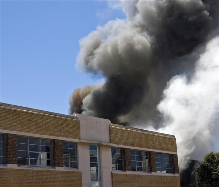 smoke billowing from a brick building