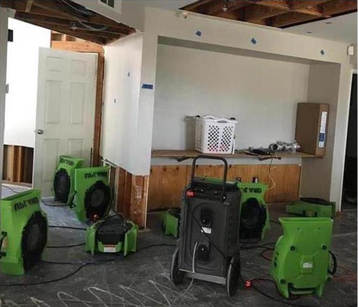 Drying equipment in a room, drywall removal