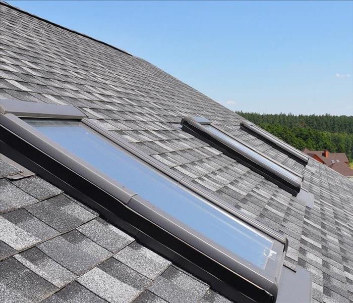 two skylights set in a shingled roof