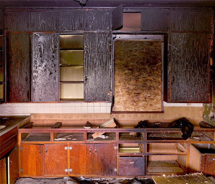 fire damaged cabinets in a kitchen
